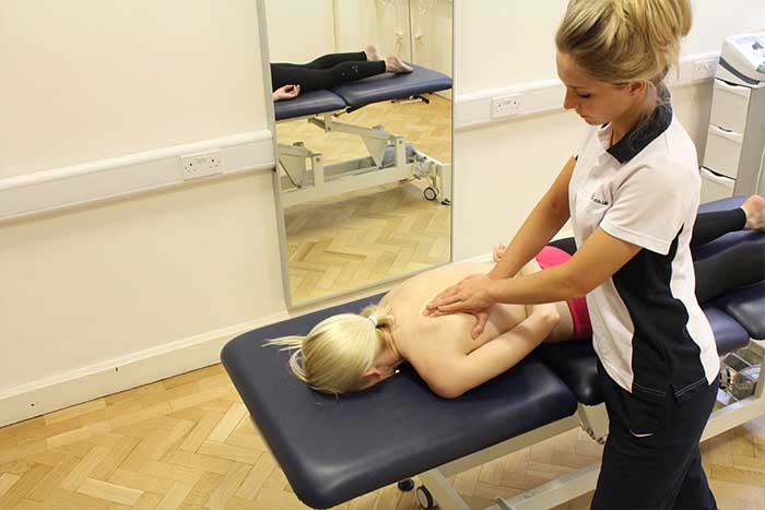 Customer receiving upper back massage in relaxed position in Manchester Physio Clinic