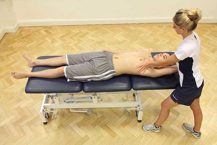Customer receiving a chest massage while in a relxed position in Manchester Physio Clinic