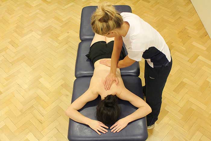 Customer receiving back massage while in a relaxed position in Manchester Physio Clinic