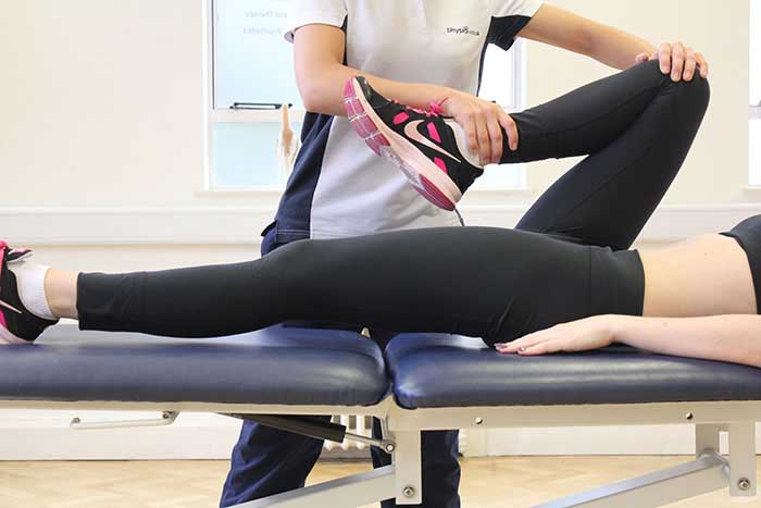 Customer receiving leg stretches while in a relaxed position