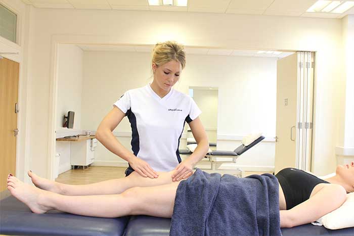 Customer receiving thigh massage while in relaxed position in Manchester Physio Clinic