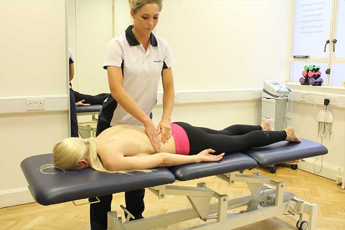 Customer receiving lower back massage in Manchester Physio Clinic