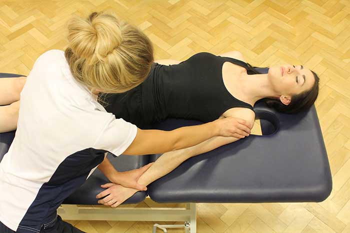 Customer receiving an arm massage while in a relaxed position