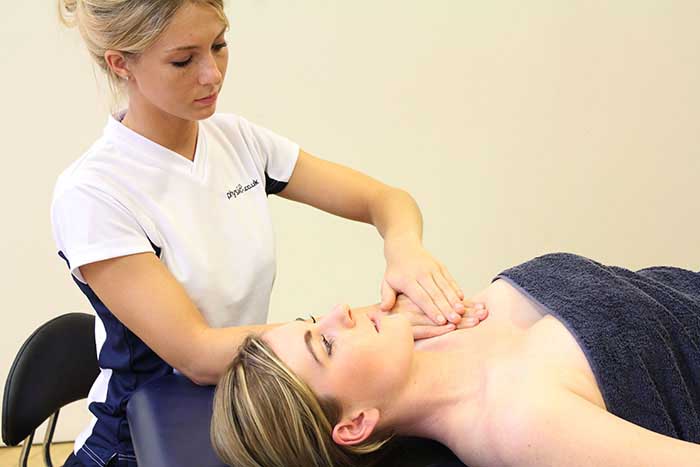 Customer receiving a chest massage while in a relaxed position in Manchester Physio Clinic