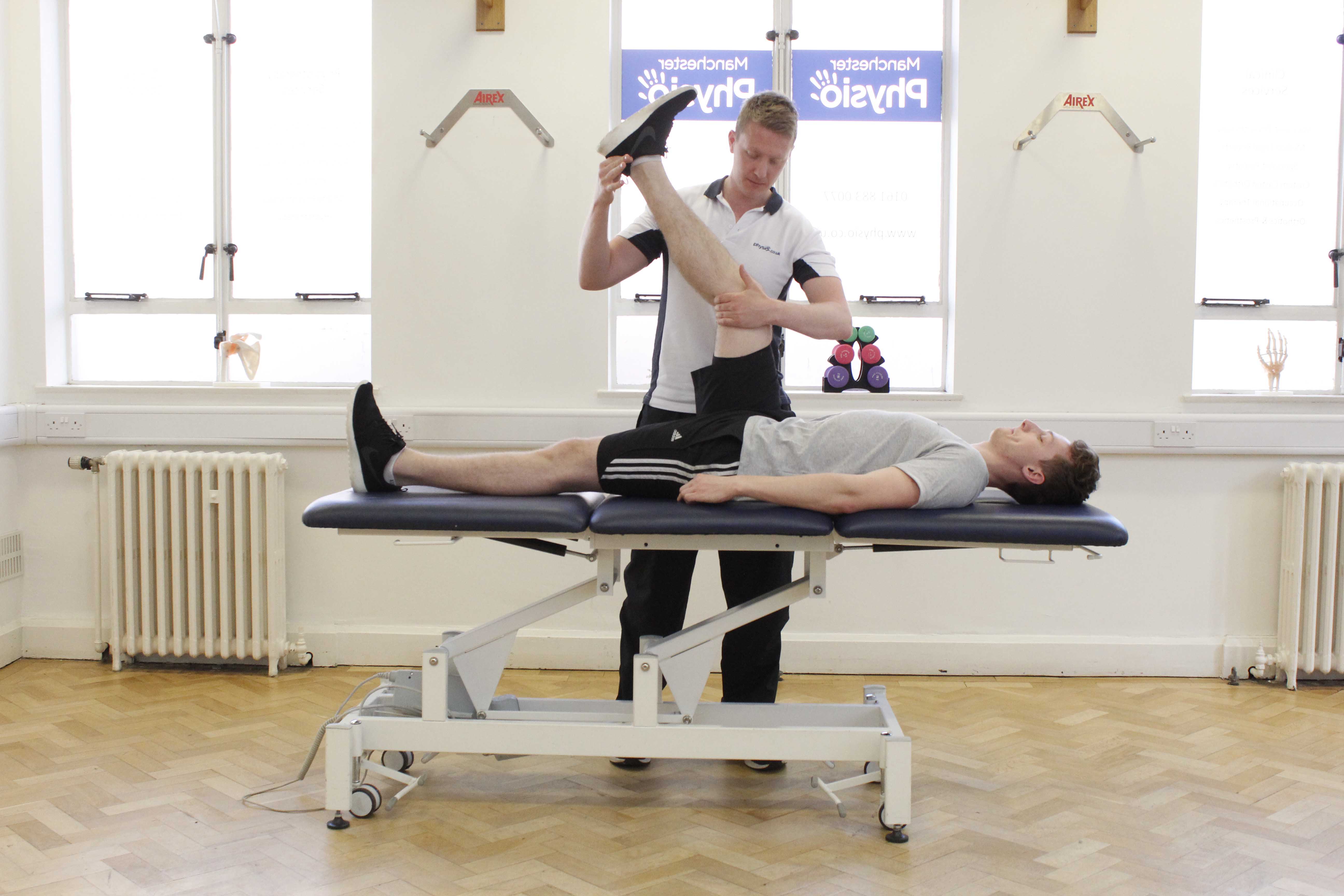 Passive stretch to hamstring and calf muscles, applied by physiotherapist