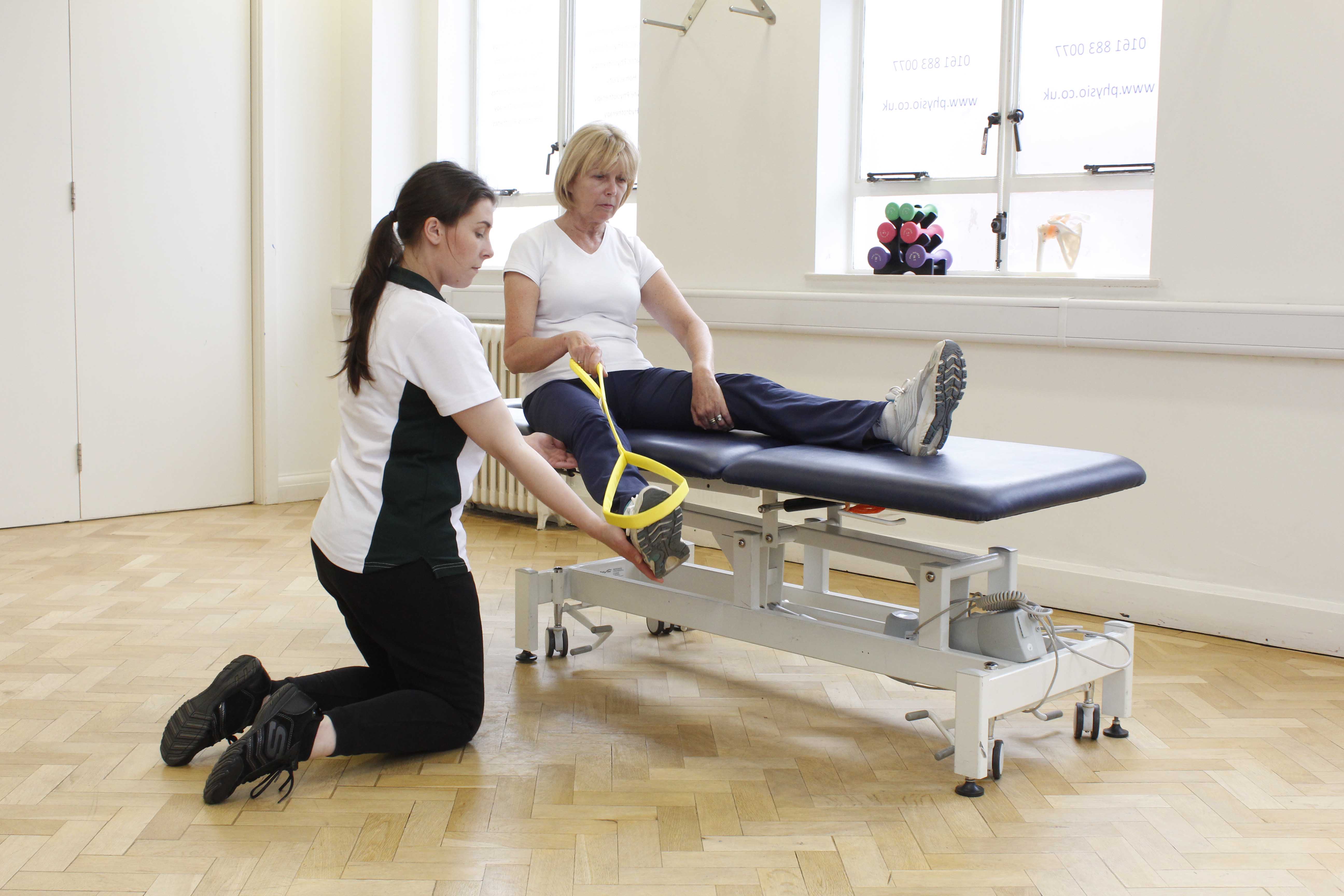 Occupational therapist assisting client with exercises to transfer in and out of bed