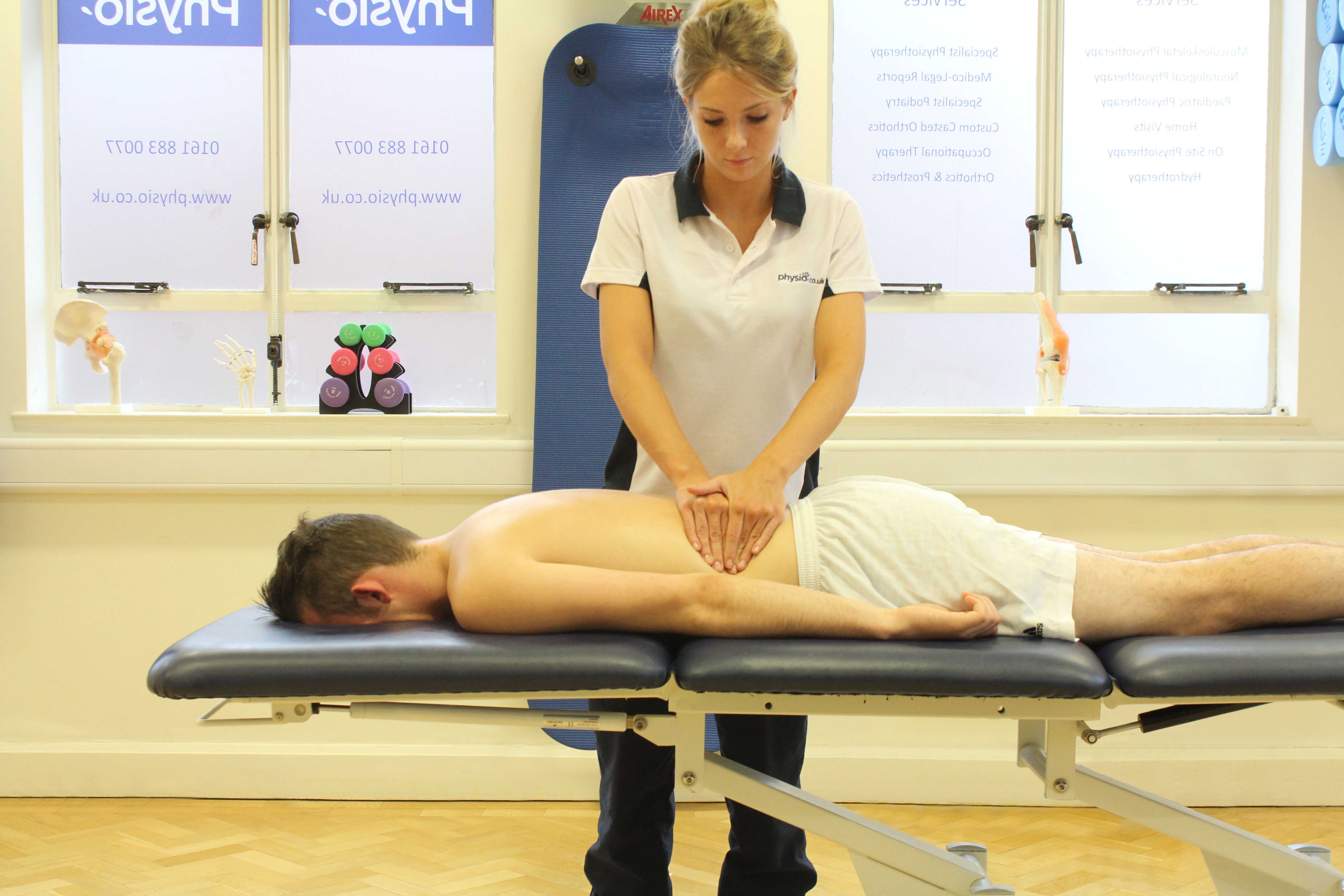 Soft tissue massage of the muscles in the lower back