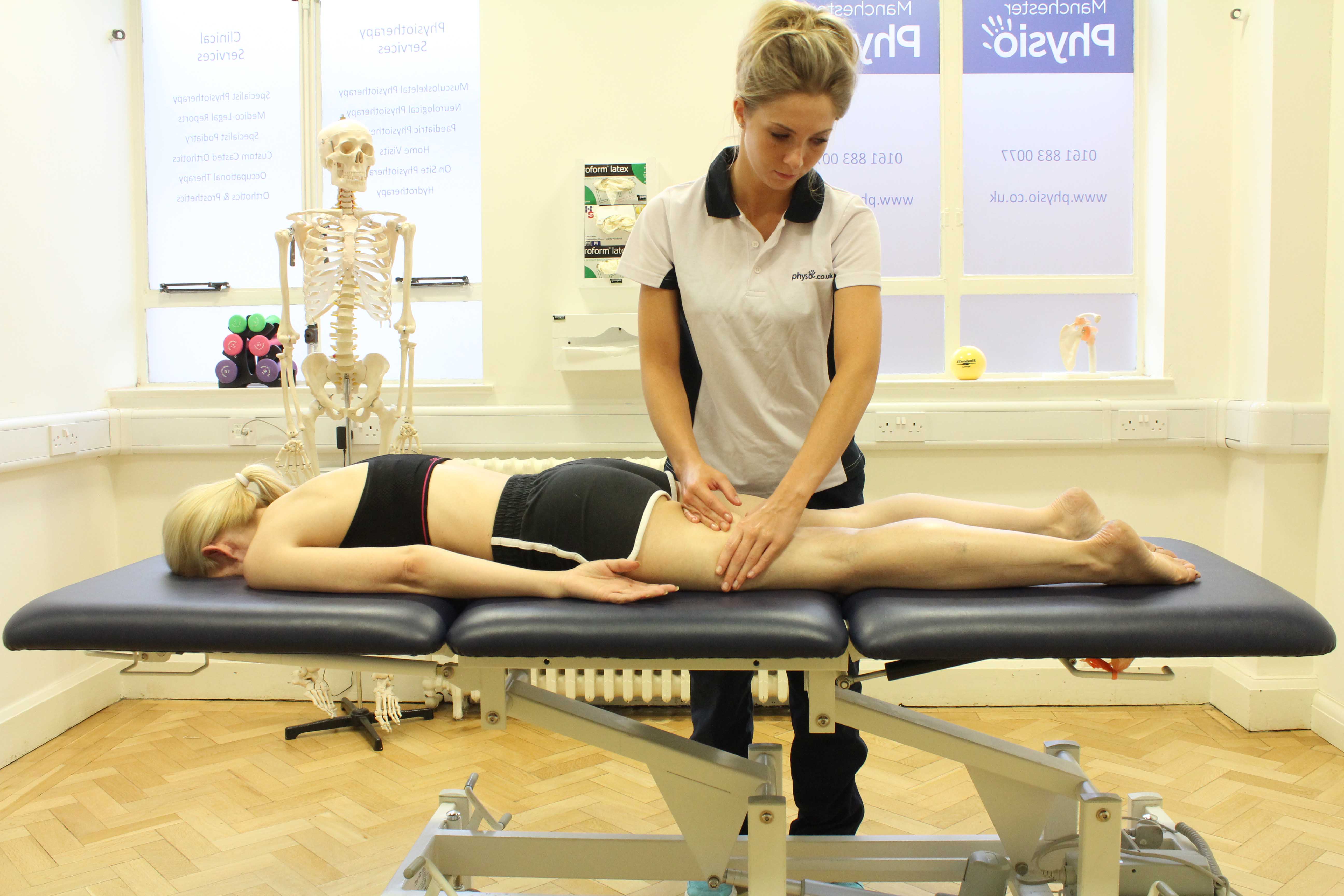 Rolling soft tissue massage of the hamstring muscles by specialist therapist