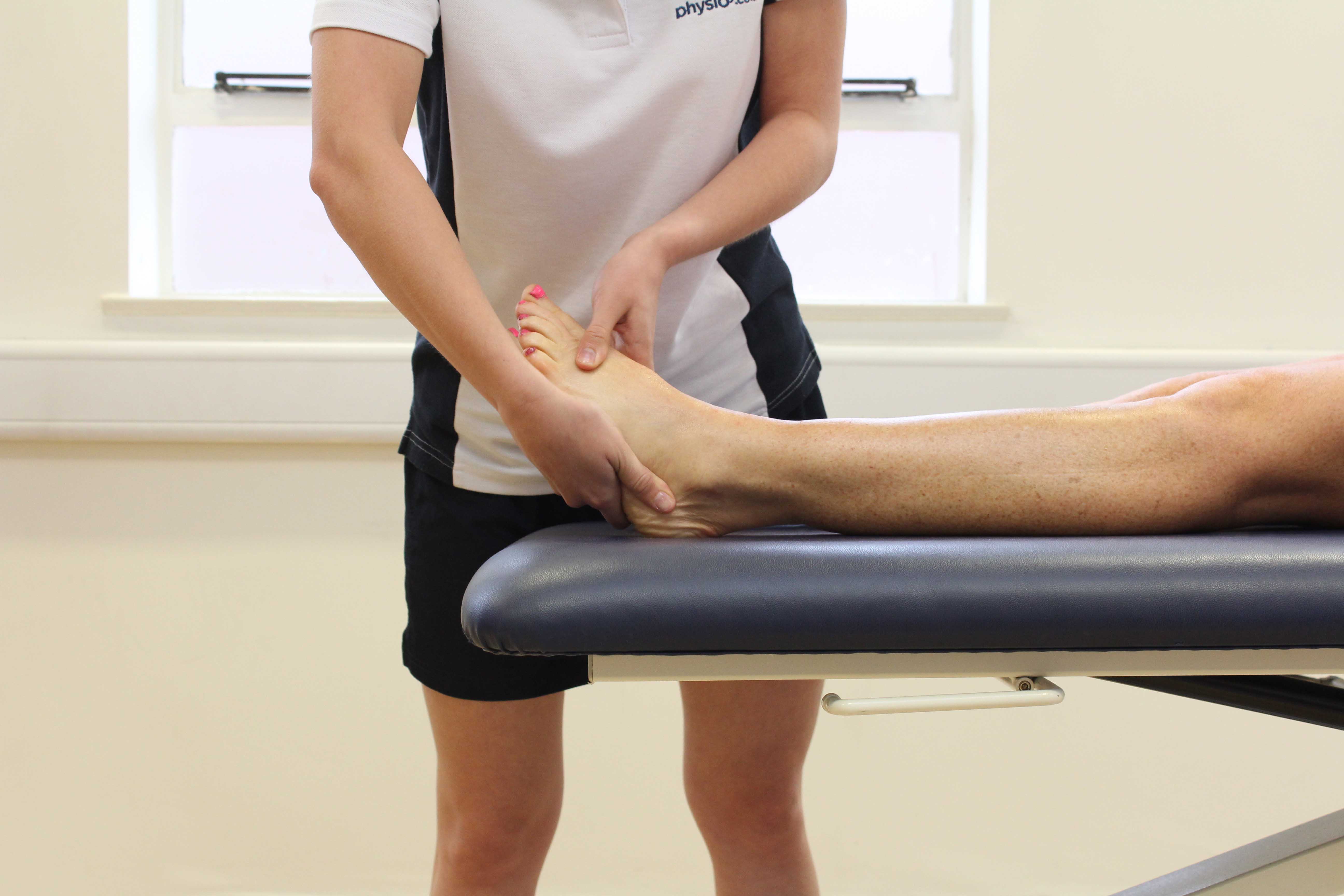Soft tissue massage applied to the bones and connective tissue on the anterior portion of the foot