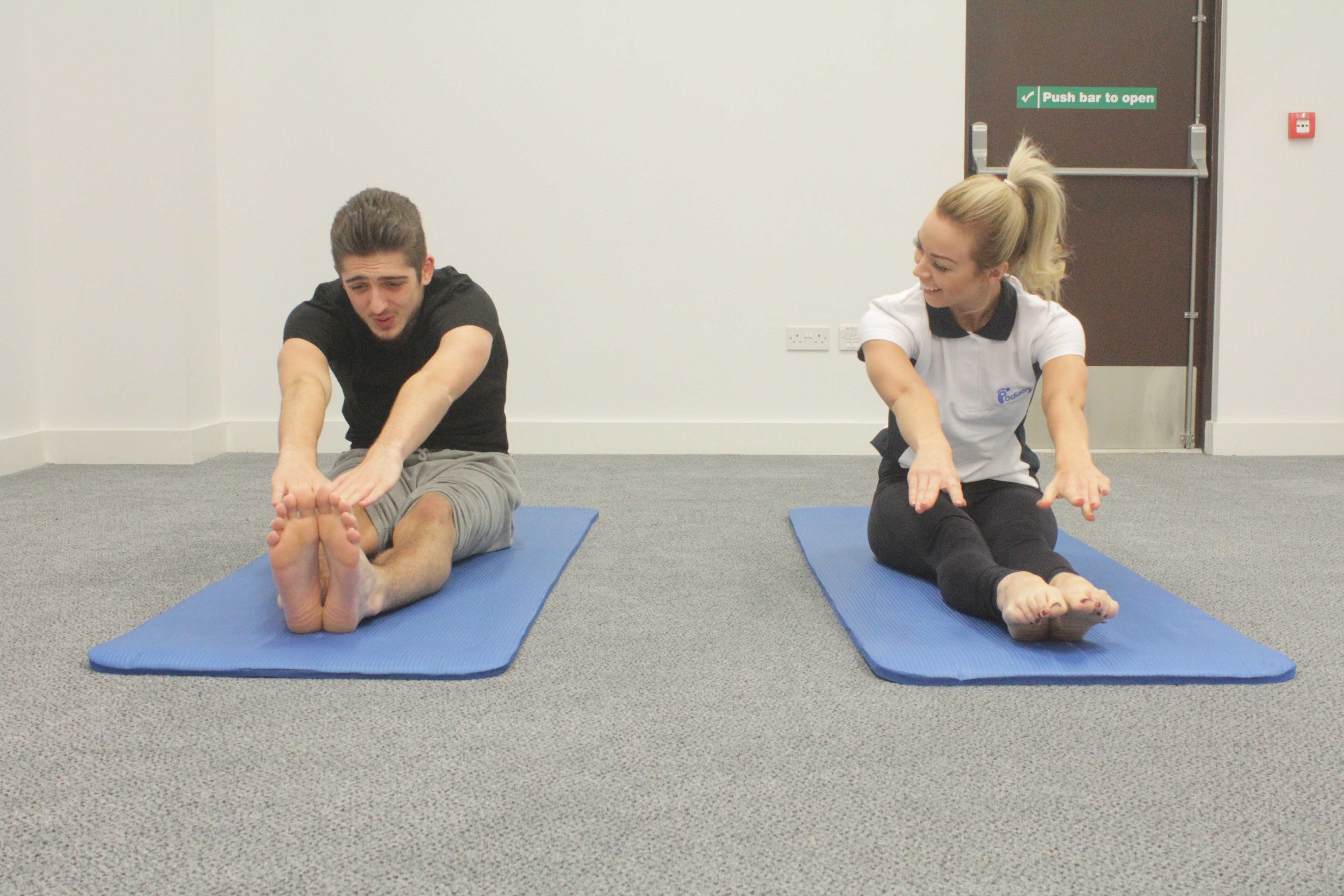 Stetch exercises using a resistance band, guided by a specialist paediatric physiotherapist