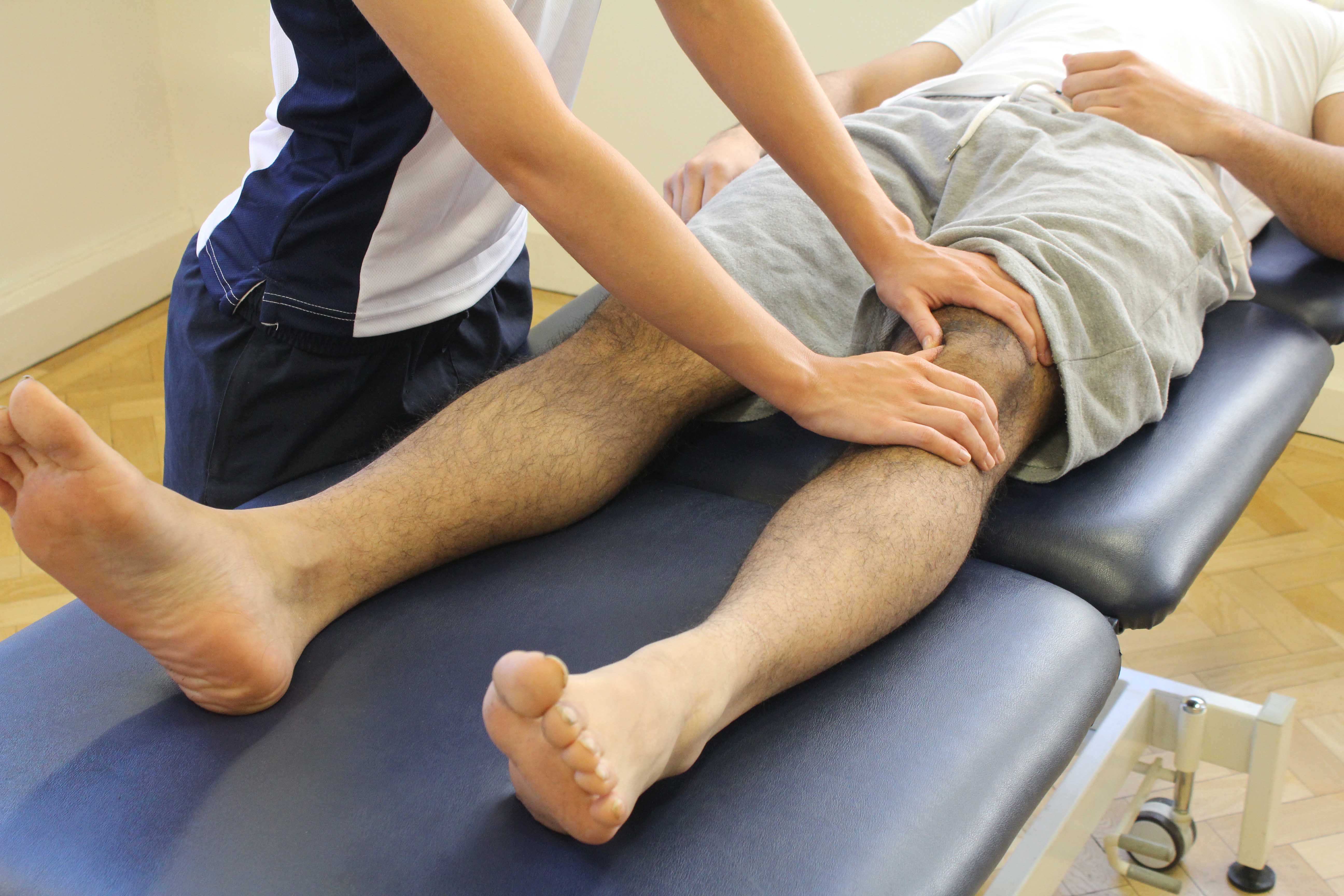 Soft tissue massage and mobilisations of the patella to disperse swelling from the knee joint