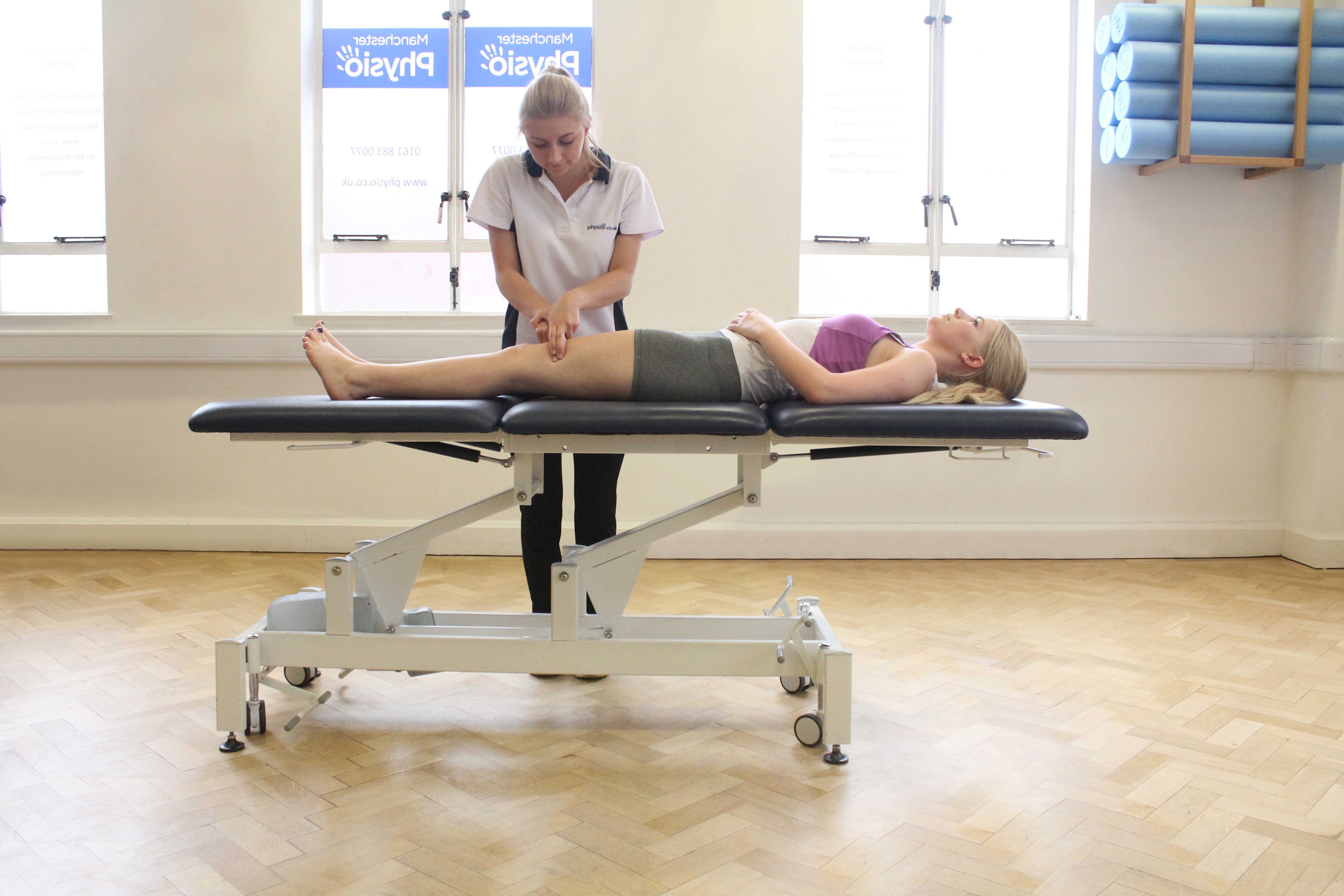 Hacking percussion massage of the quadricep muscles by a specialist MSK therapist