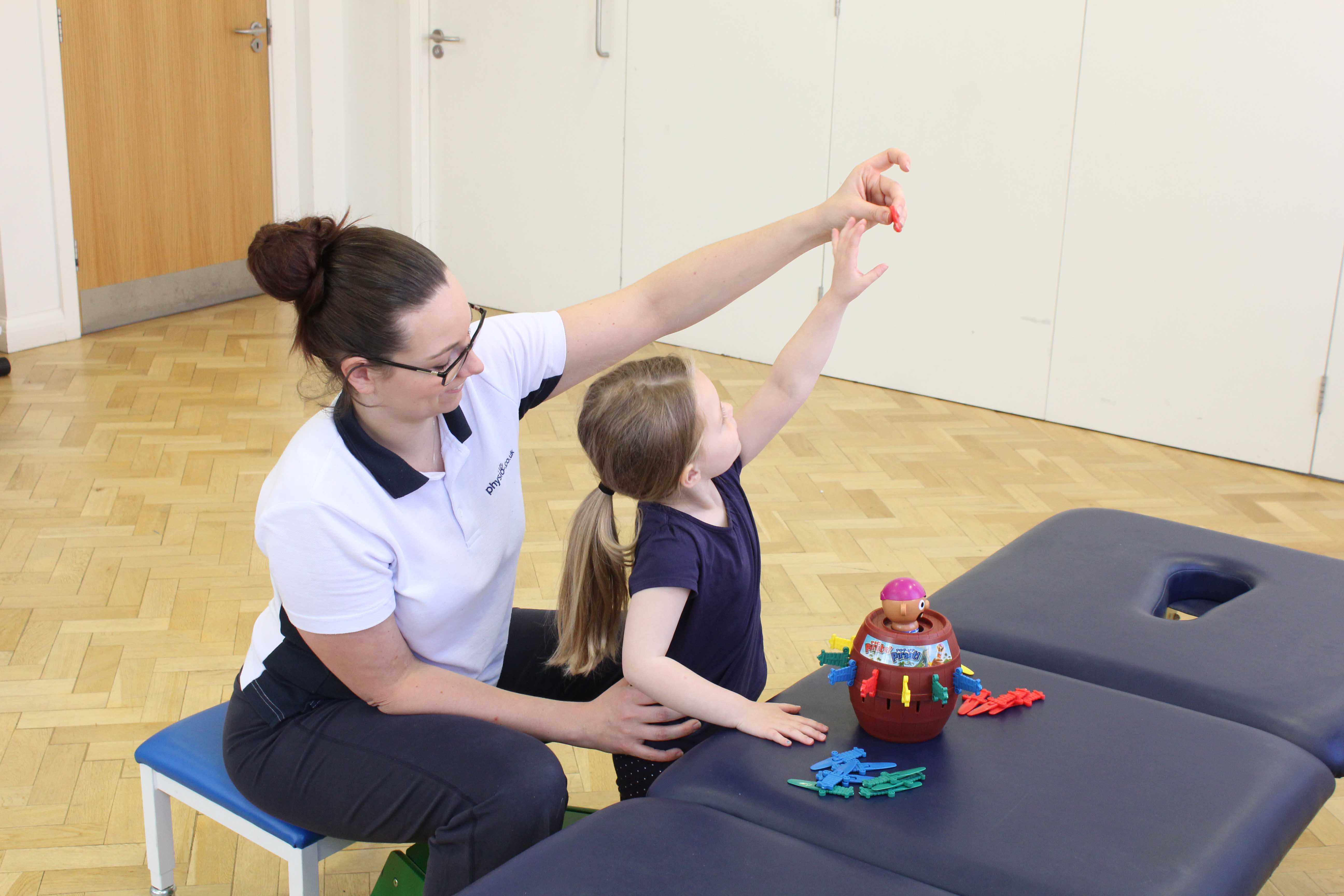 Developing fine motor skills through play activities supervised bya paediatric physiotherapist